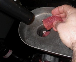 meat into grinder